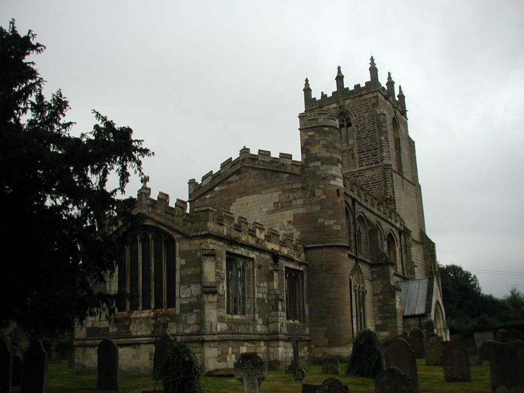 brown stone church with crenellations