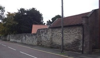 stone wall alongside a road