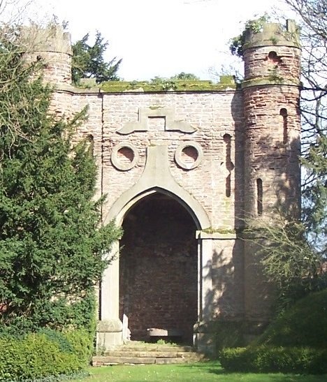 gateway with large arch door and two round corner towers