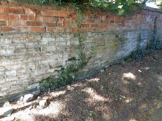 red wall, white lower down, some ivy