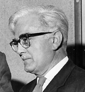 Black and white photo of side view of man with glasses and white hair