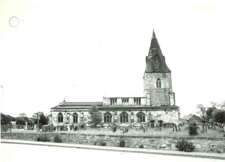 black and white photo of church with tall pointed tower