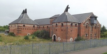red brick buildings with grey funnels on roof